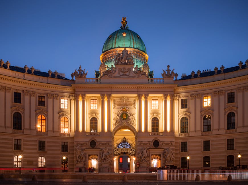 The building is lit up at night with a dome
